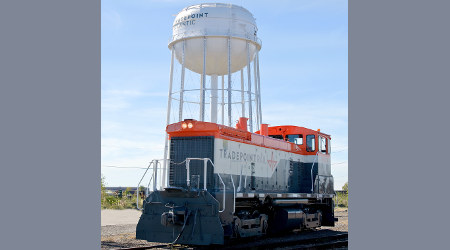Tradepoint locomotive rests near a water tower